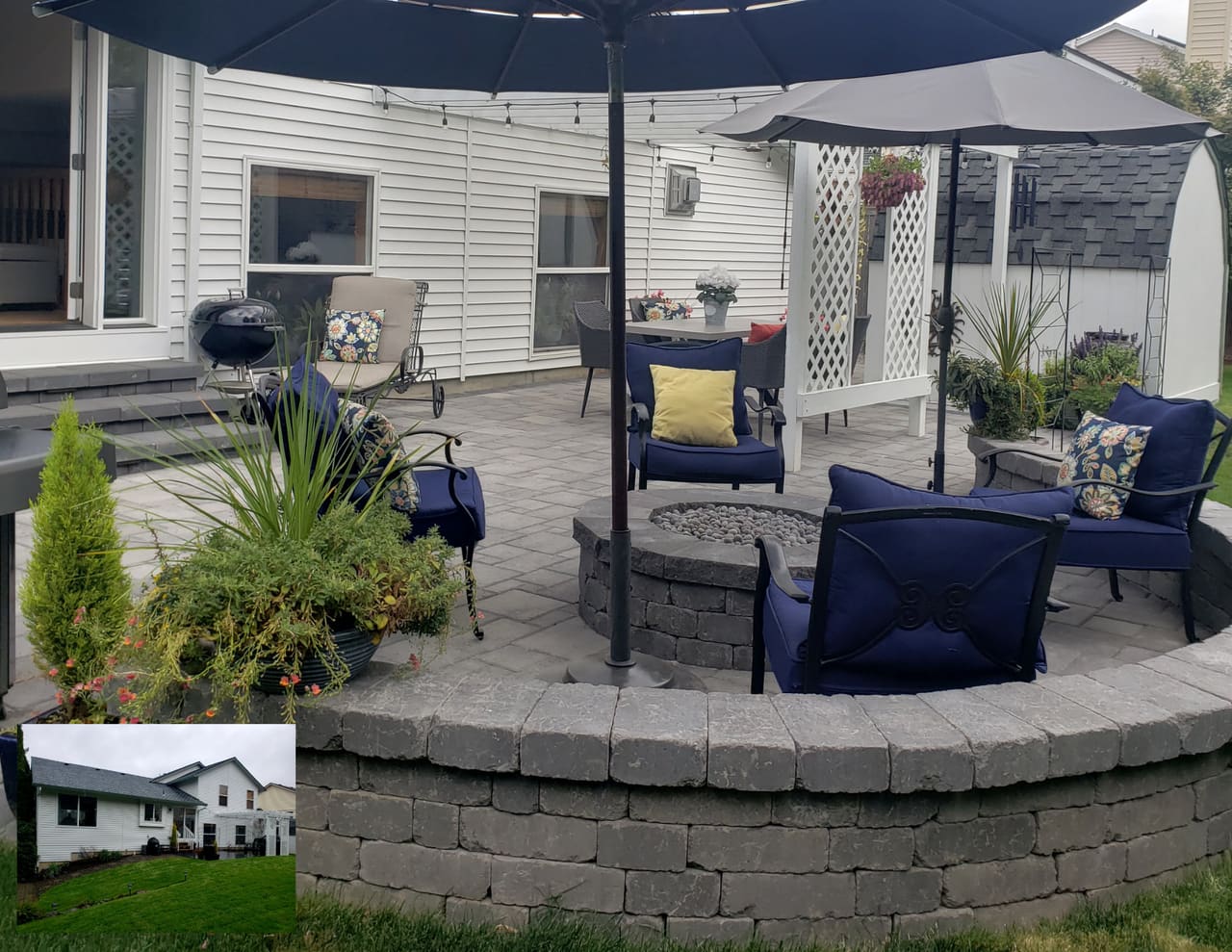 A paver patio with cozy chairs gathered around a built-in gas fire pit and sitting wall.
