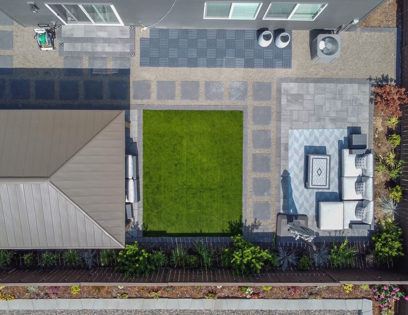 Overhead drone view of a Ridgefield patio arranged around a rectangular lawn